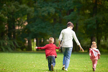 Image showing happy family playing together outdoor in park