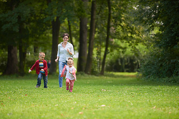 Image showing happy family playing together outdoor in park