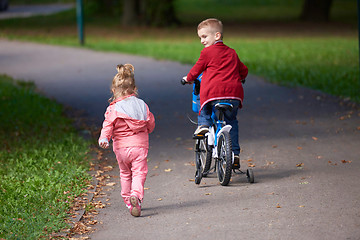 Image showing boy and girl with bicycle