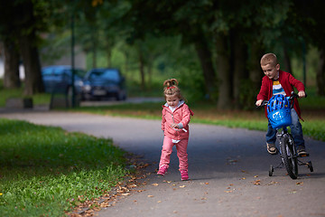 Image showing boy and girl with bicycle