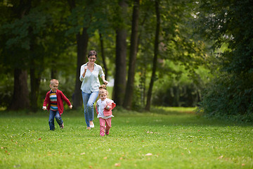 Image showing happy family playing together outdoor in park