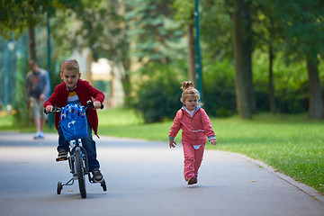 Image showing boy and girl with bicycle