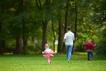 Image showing happy family playing together outdoor in park