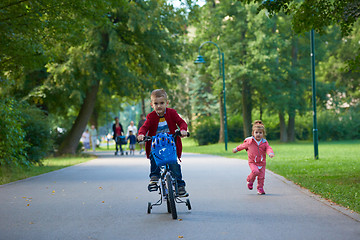 Image showing boy and girl with bicycle