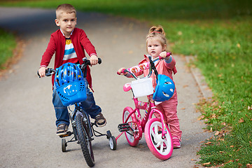 Image showing boy and girl with bicycle