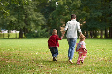 Image showing happy family playing together outdoor in park