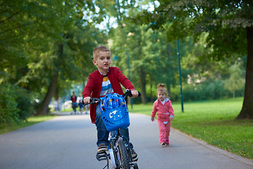 Image showing boy and girl with bicycle