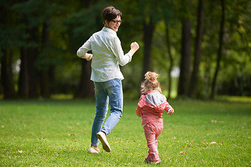 Image showing happy family playing together outdoor in park