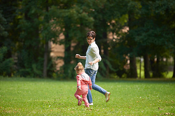 Image showing happy family playing together outdoor in park