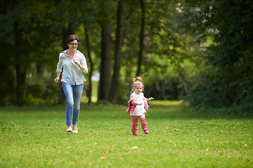 Image showing happy family playing together outdoor in park