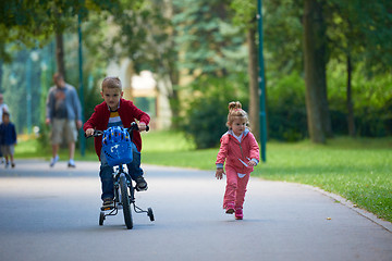 Image showing boy and girl with bicycle