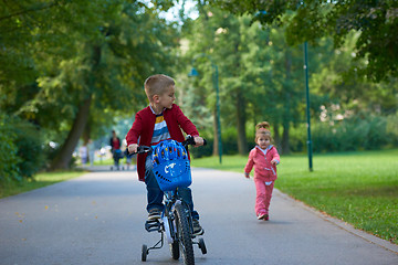 Image showing boy and girl with bicycle