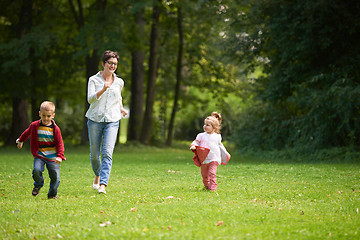 Image showing happy family playing together outdoor in park