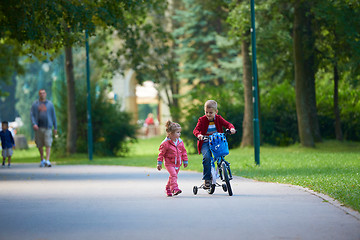 Image showing boy and girl with bicycle