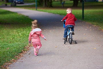 Image showing boy and girl with bicycle