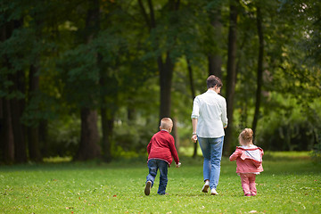 Image showing happy family playing together outdoor in park