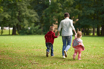 Image showing happy family playing together outdoor in park