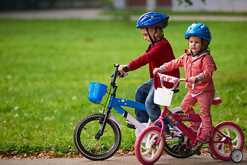 Image showing boy and girl with bicycle