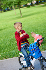 Image showing boy and girl with bicycle