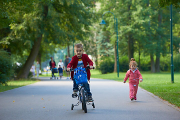 Image showing boy and girl with bicycle