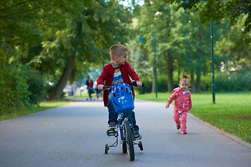 Image showing boy and girl with bicycle