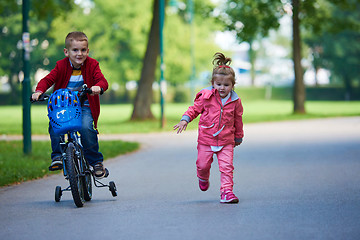 Image showing boy and girl with bicycle