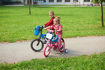 Image showing boy and girl with bicycle