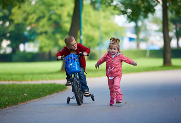 Image showing boy and girl with bicycle