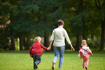 Image showing happy family playing together outdoor in park