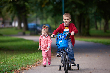 Image showing boy and girl with bicycle