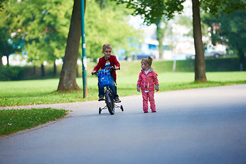 Image showing boy and girl with bicycle