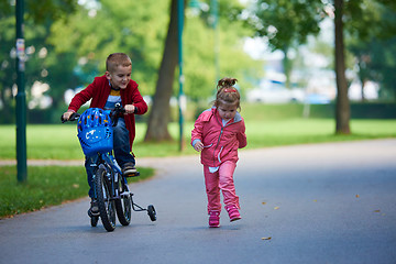 Image showing boy and girl with bicycle