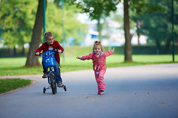 Image showing boy and girl with bicycle