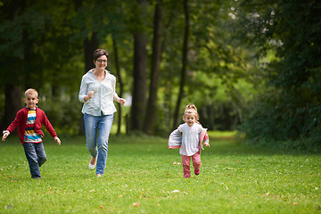 Image showing happy family playing together outdoor in park