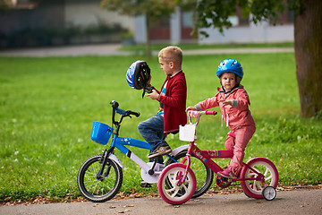 Image showing boy and girl with bicycle