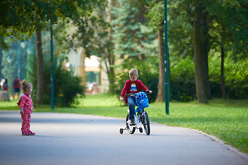 Image showing boy and girl with bicycle