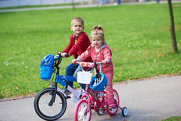 Image showing boy and girl with bicycle