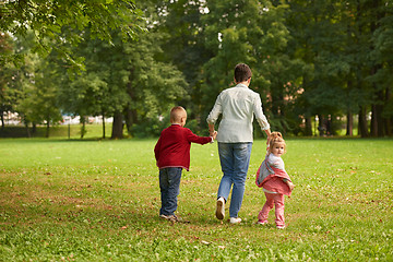 Image showing happy family playing together outdoor in park