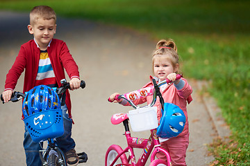 Image showing boy and girl with bicycle