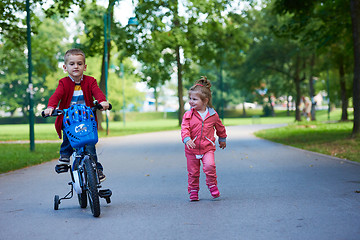 Image showing boy and girl with bicycle