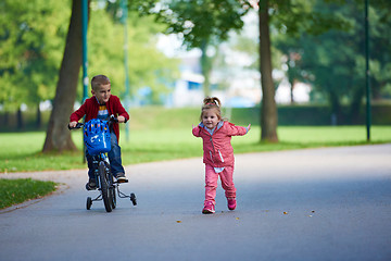 Image showing boy and girl with bicycle