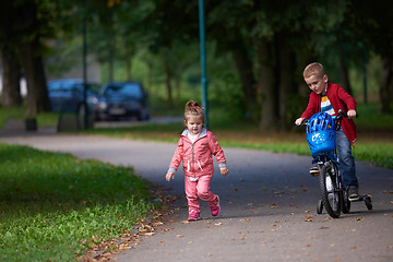 Image showing boy and girl with bicycle