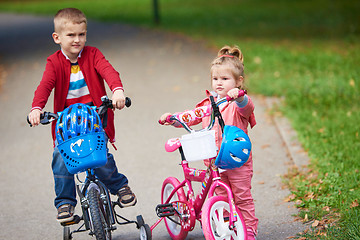 Image showing boy and girl with bicycle