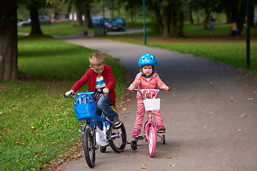 Image showing boy and girl with bicycle