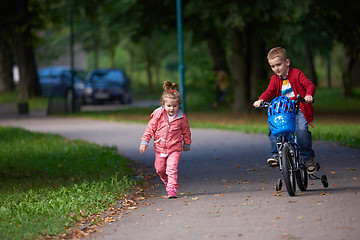 Image showing boy and girl with bicycle