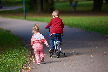 Image showing boy and girl with bicycle