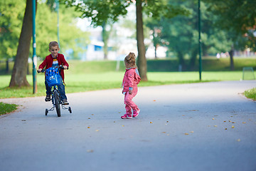 Image showing boy and girl with bicycle