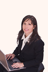 Image showing Smilling brunette working on a laptop