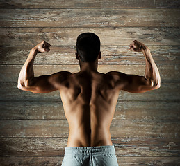 Image showing young man or bodybuilder showing biceps