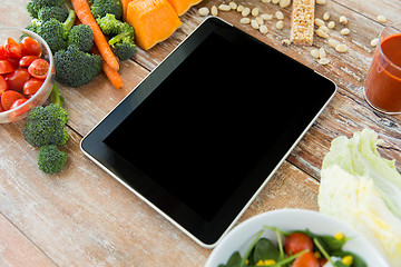 Image showing close up of blank tablet pc screen and vegetables